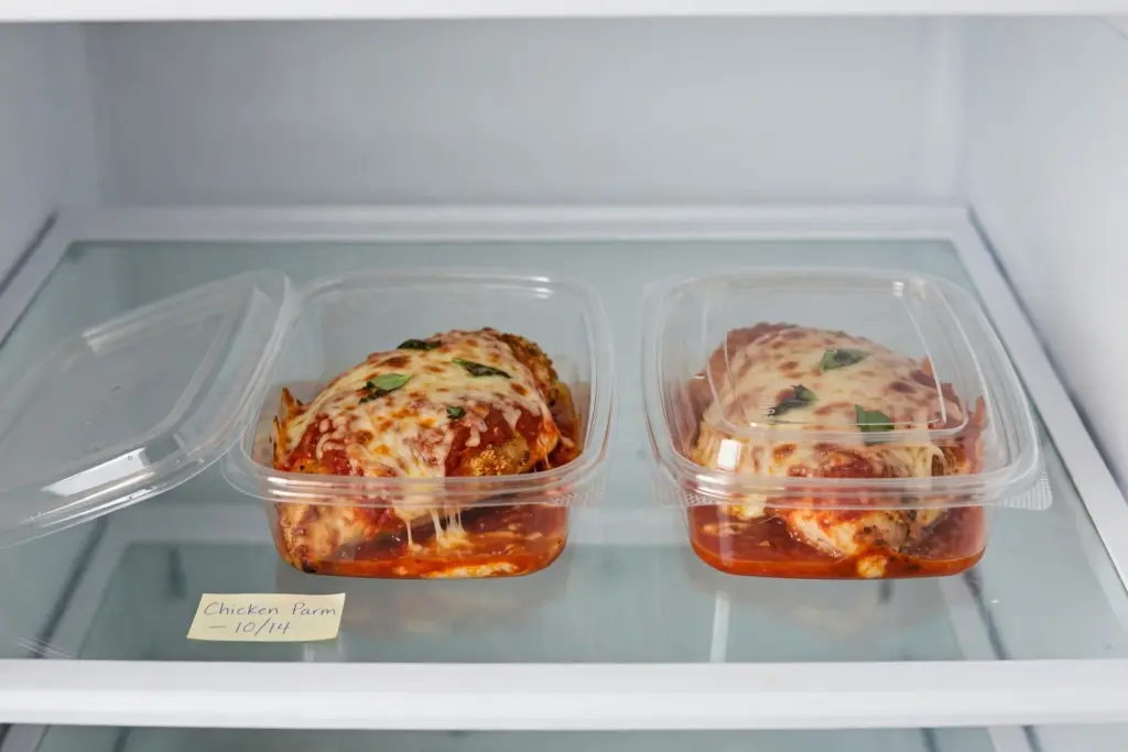 Crispy Baked Chicken Parmesan Recipe (Stays Crunchy Under the Sauce) 6 chicken parmesan portioned into a container ready for the fridge or freezer